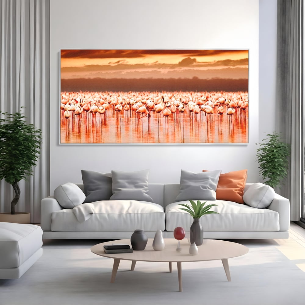 Tablou canvas cu tablou canvas cu stol de flamingo la apus, in rama de aluminiu argintiu, pe perete intr-un living